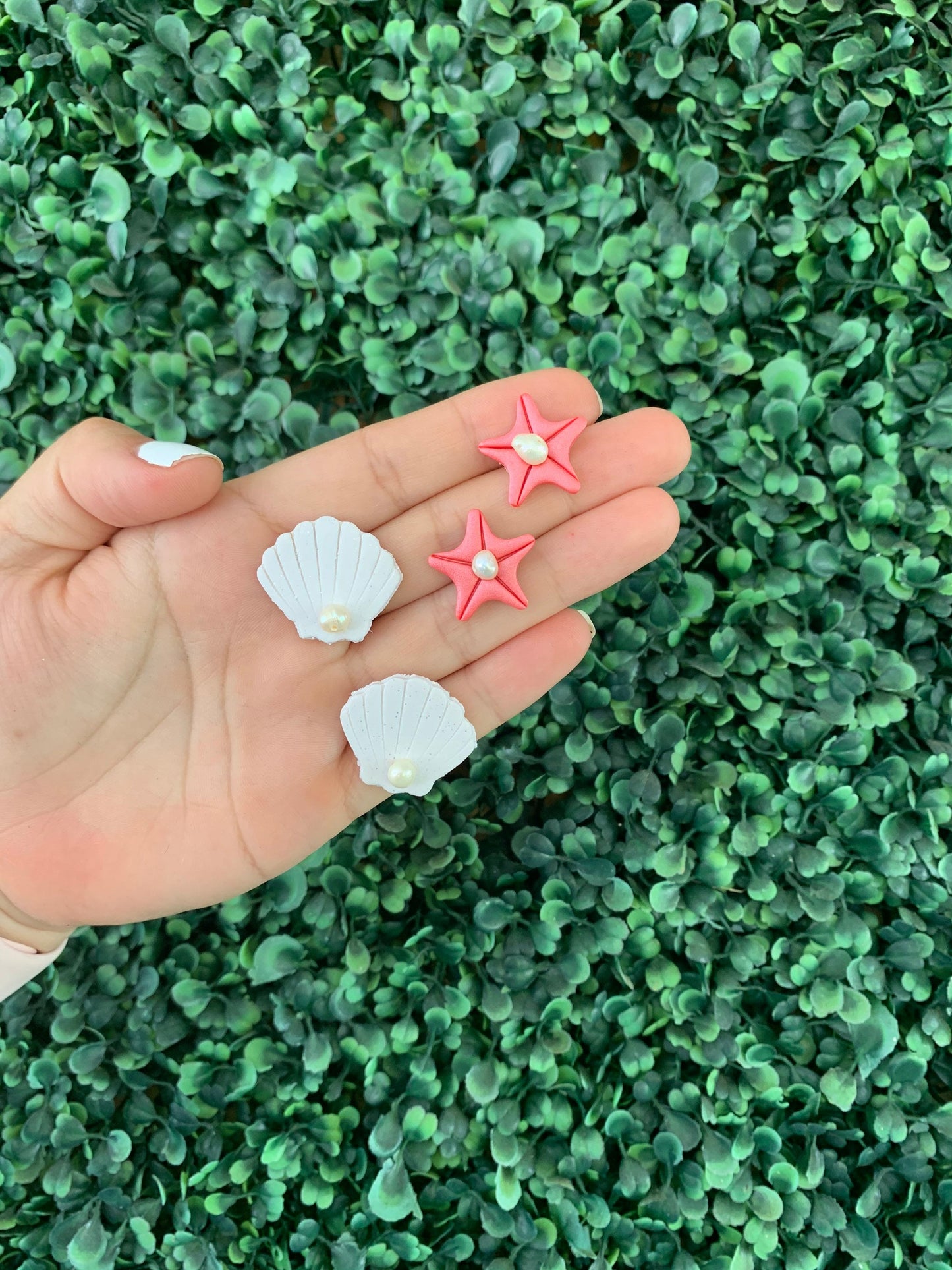 A pair of handcrafted polymer clay earrings featuring 18K gold plated earring posts and a mini pearl