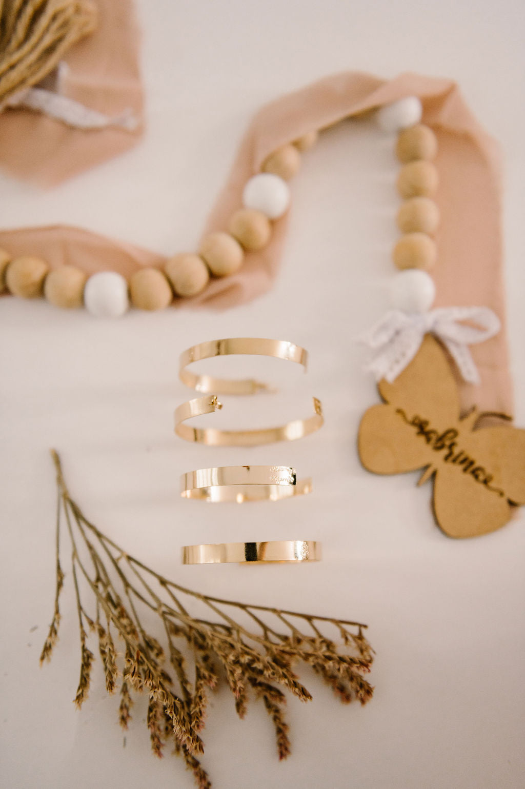 A close up of a trio of gold filled adjustable bracelets.