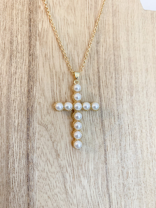 18k gold plated pearl cross necklace on a white background, with the cross centerpiece in focus. A beautiful and elegant jewelry piece to add to your collection.