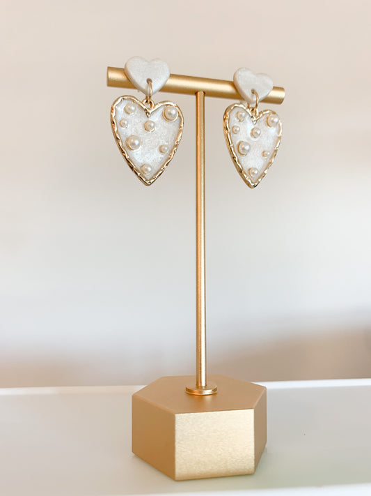 Handmade polymer clay earrings with a freshwater pearl and 18k gold plated earring posts. Perfect for adding sophistication to any look.