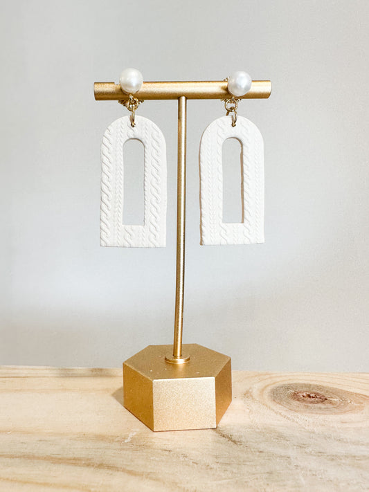 Handmade polymer clay earrings with a freshwater pearl and 18k gold plated earring posts. Perfect for adding sophistication to any look.