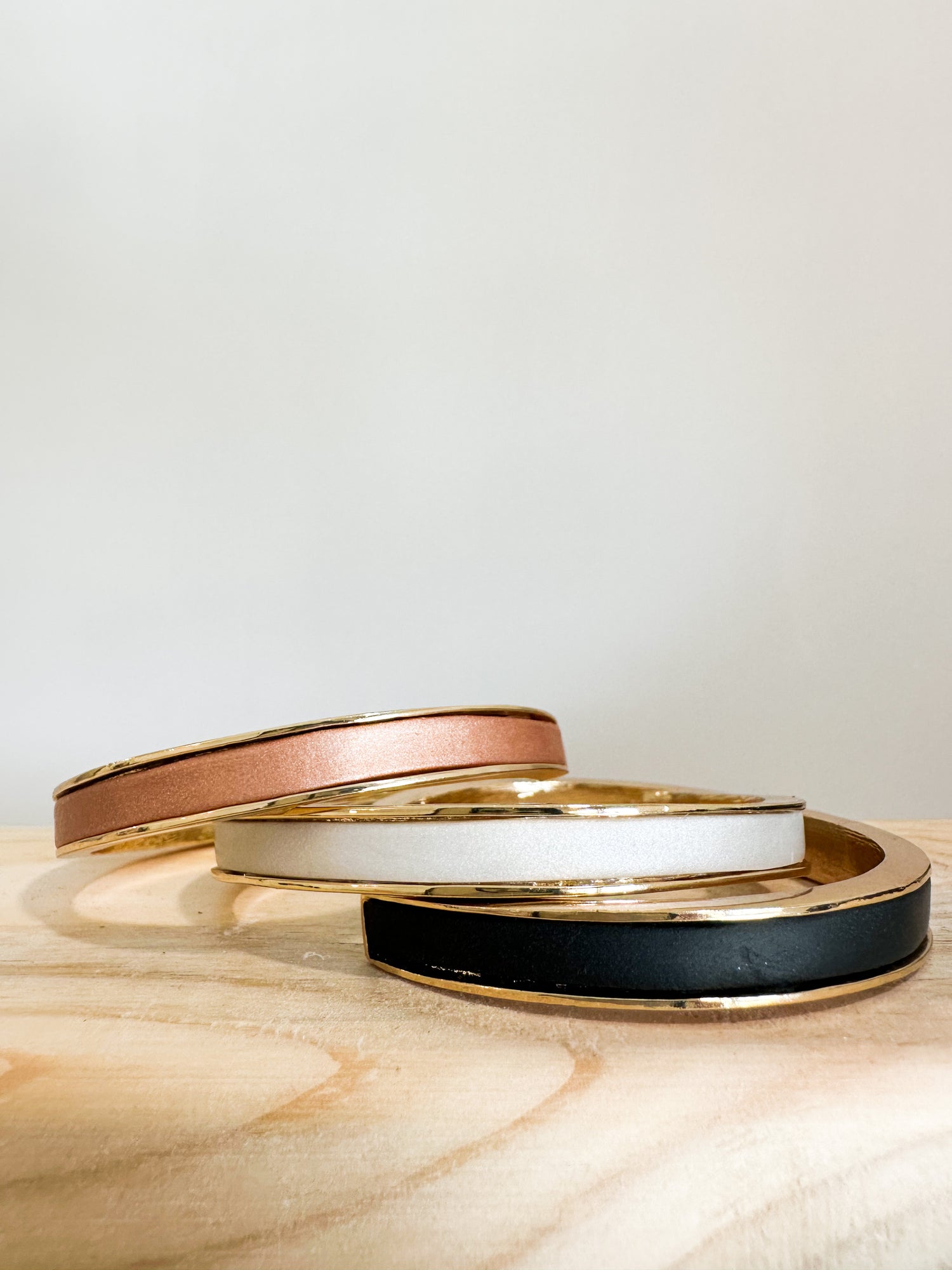 A close-up of a beautifully designed adjustable gold filled bangle with intricate polymer clay embellishments on a white background.