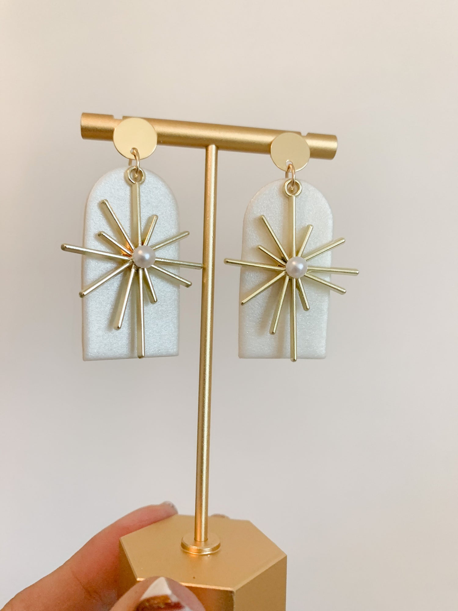 Handmade polymer clay earrings with a freshwater pearl and 18k gold plated earring posts. Perfect for adding sophistication to any look.