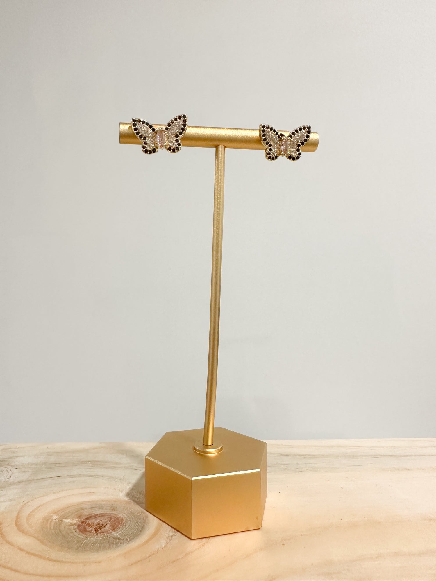 Butterfly shaped gold stud earrings adorned with black cubic zirconia
