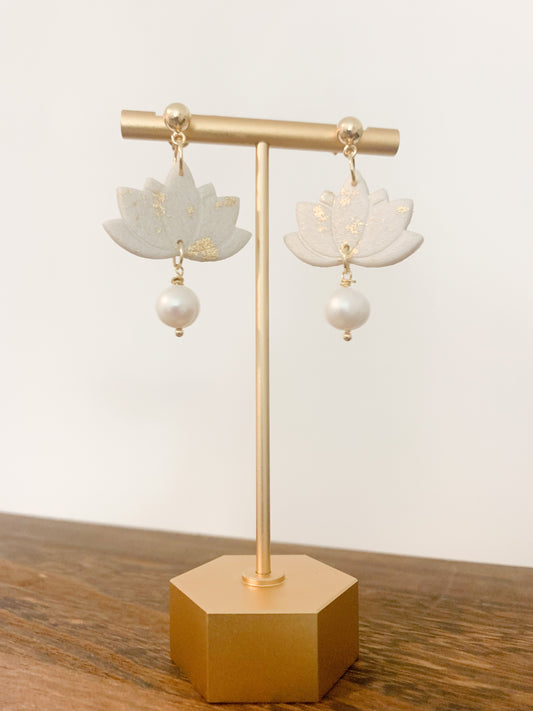 Handmade polymer clay earrings with a freshwater pearl and 18k gold plated earring posts. Perfect for adding sophistication to any look.