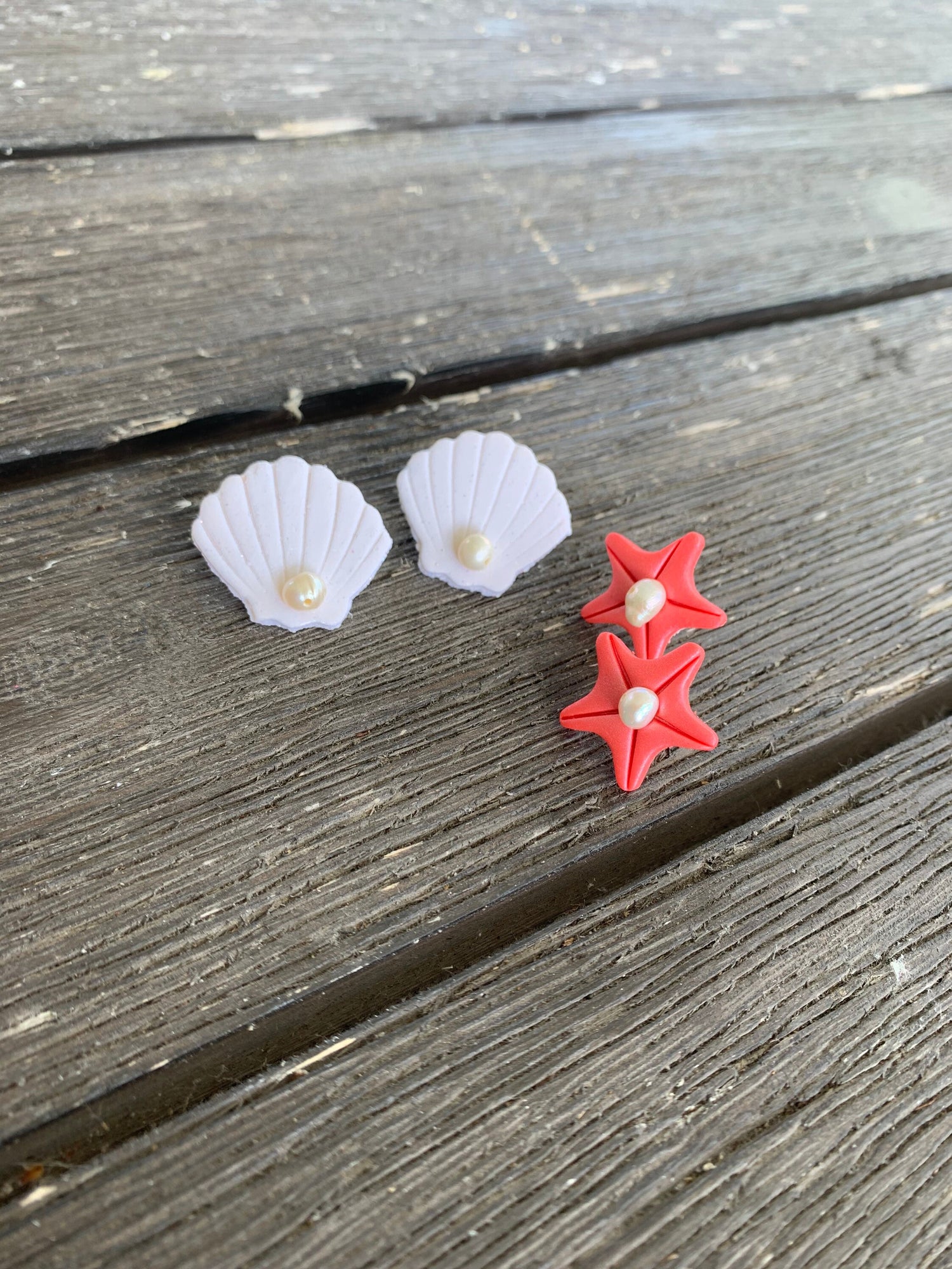 A pair of handcrafted polymer clay earrings featuring 18K gold plated earring posts and a mini pearl