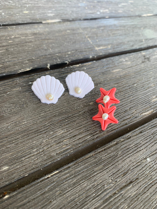 A pair of handcrafted polymer clay earrings featuring 18K gold plated earring posts and a mini pearl