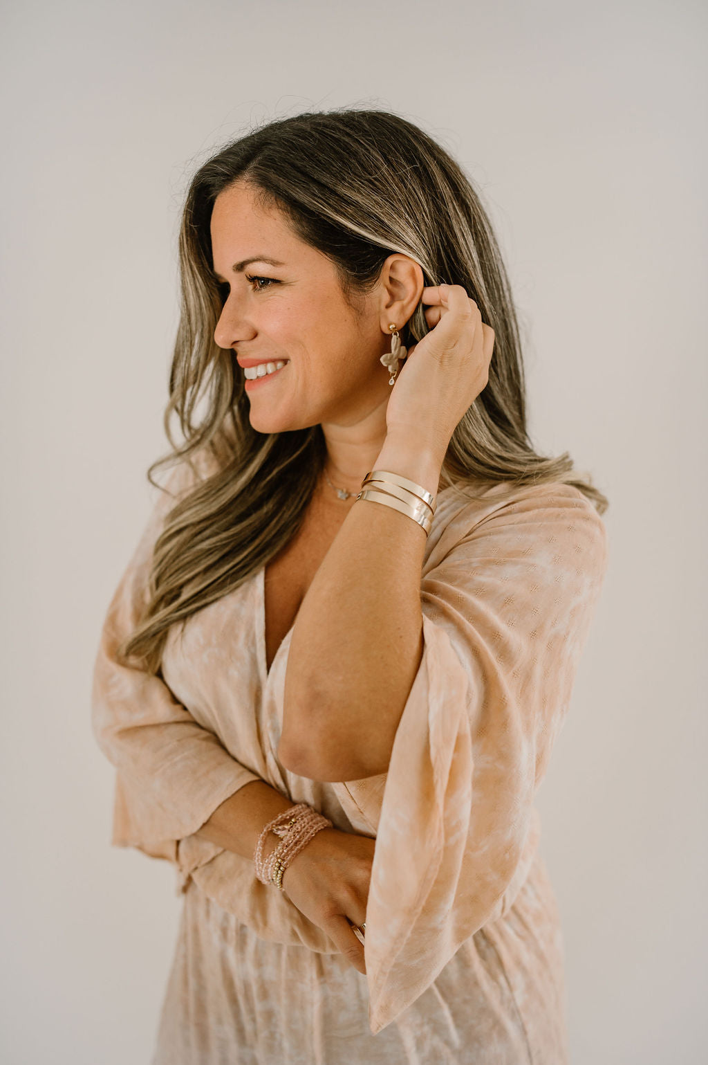 Natalie from Growing the Pizarro's modeling a trio of gold filled adjustable bracelets.