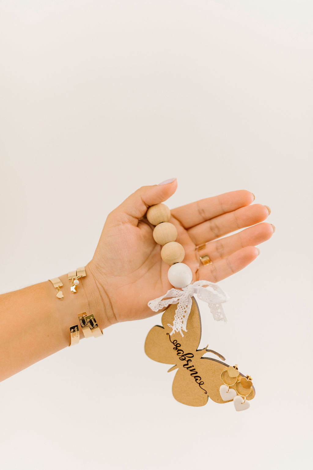 A close up of the gold filled adjustable bracelets with various charms.