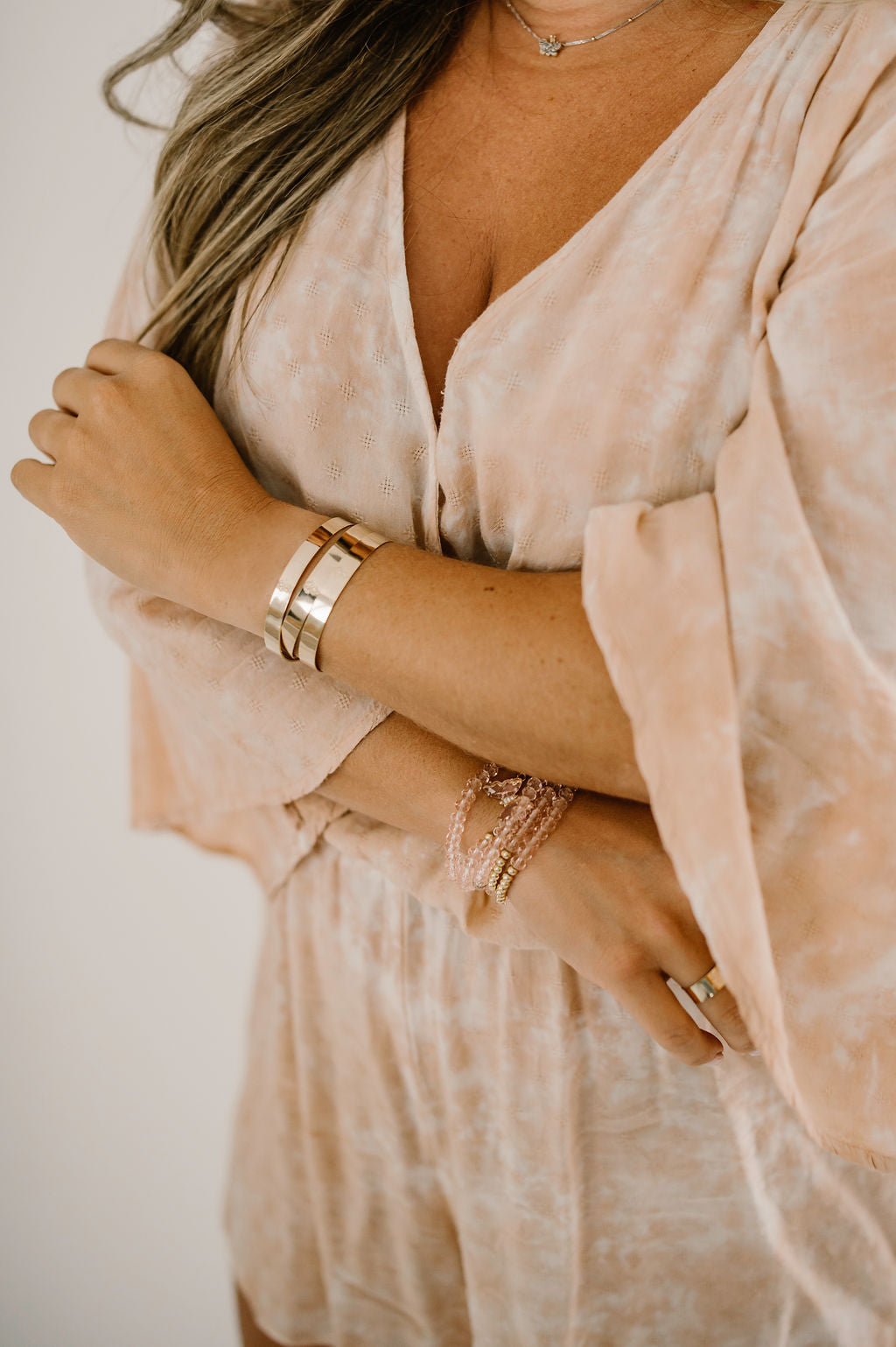 A close up of Natalie from Growing the Pizarro's modeling the golden Halo Collection.