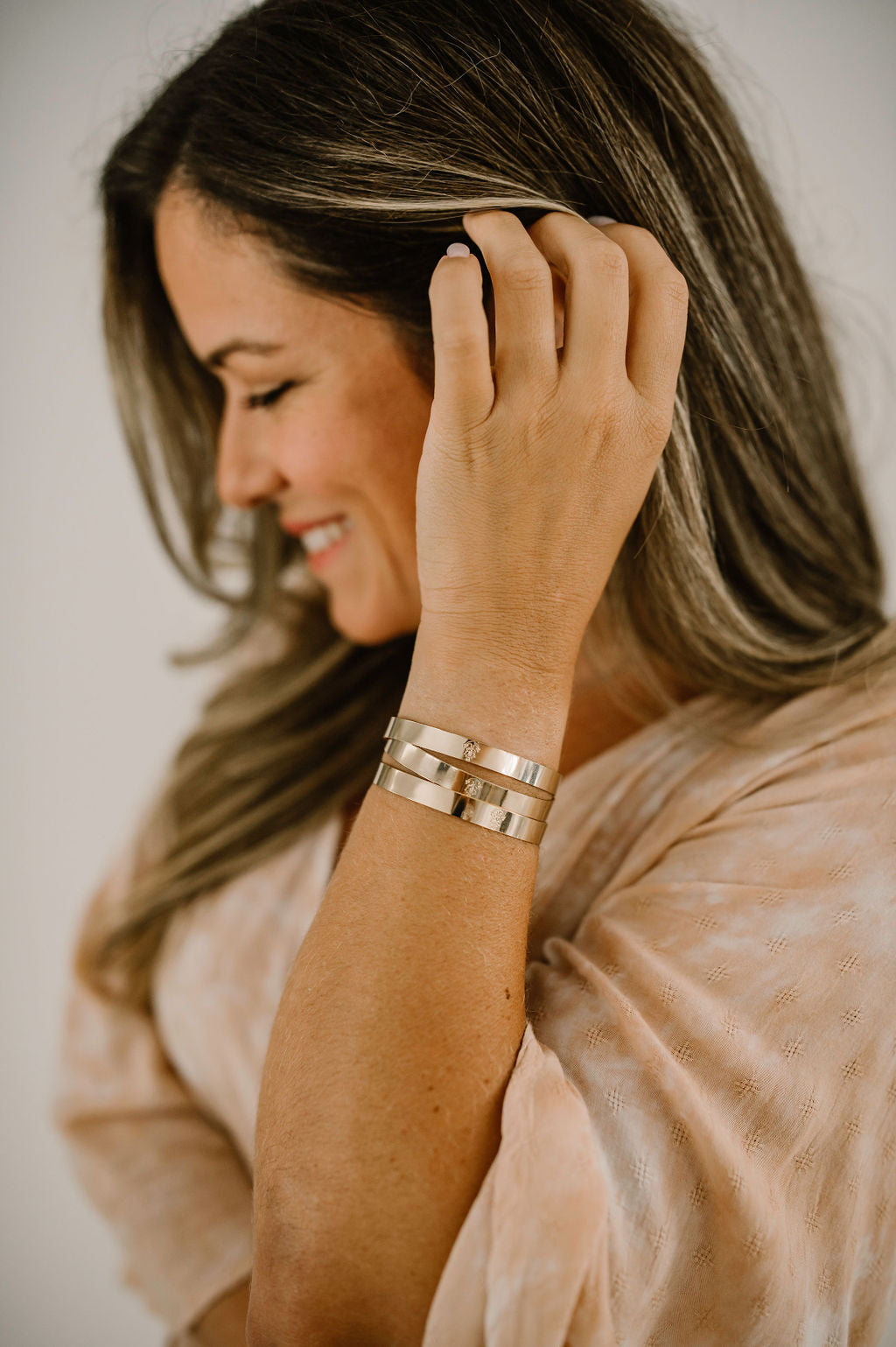 Natalie from Growing the Pizarro's modeling a trio of gold filled adjustable bracelets. 